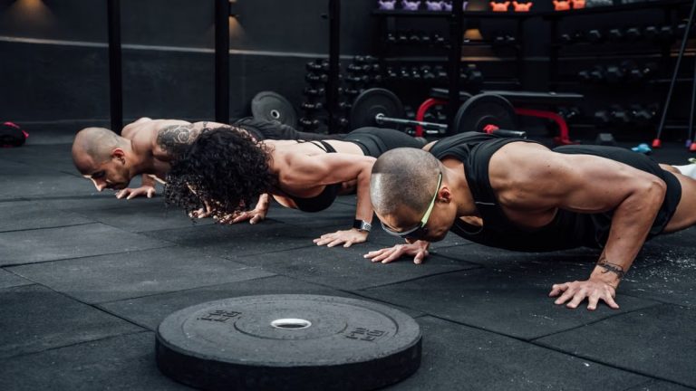 Group workout session in a Mexico City gym with athletes doing push-ups.
